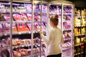 Woman choosing a dairy products at supermarket